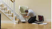 a technician fitting a stannah stairlift