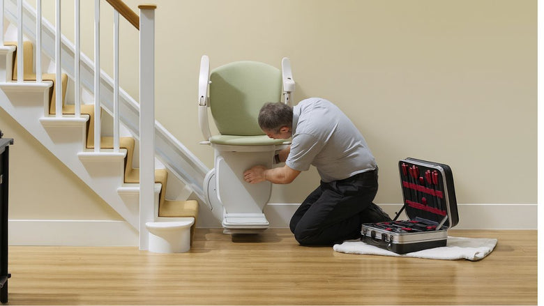 a technician fitting a stannah stairlift