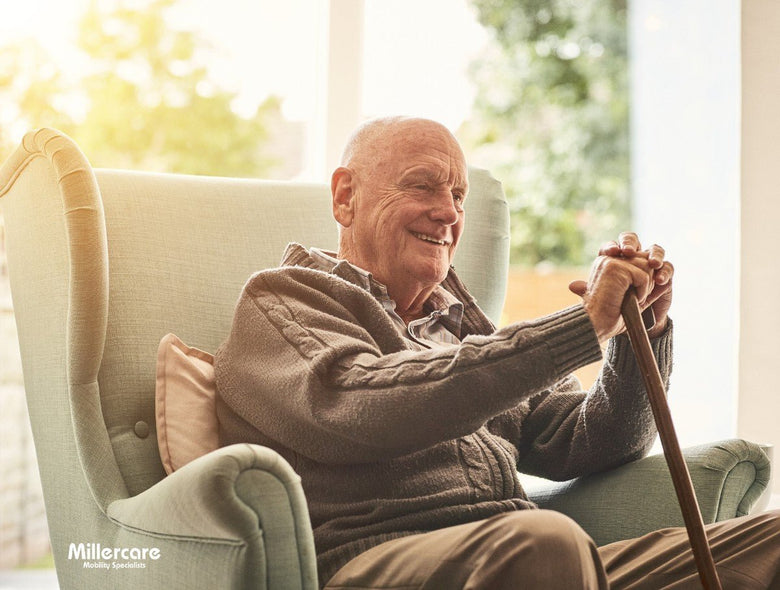 happy elderly gentleman sat in a chair
