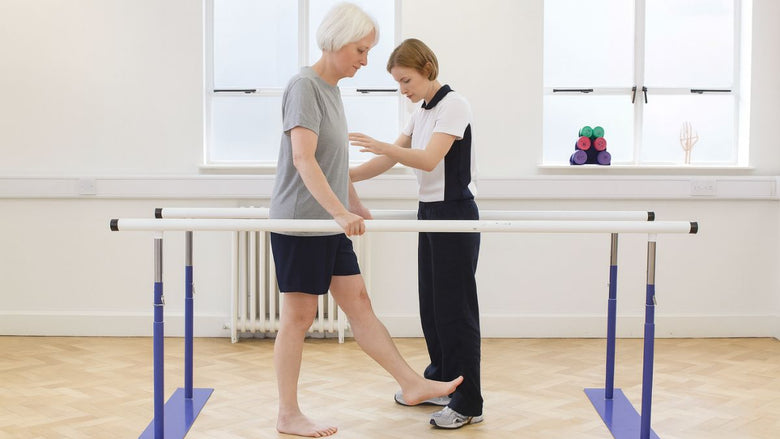 a lady working with a physiotherapist on her balance