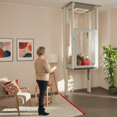 Woman using a home elevator in a modern living room.
