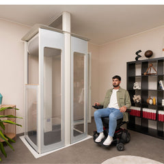 Man in a wheelchair using a home lift in a living room.